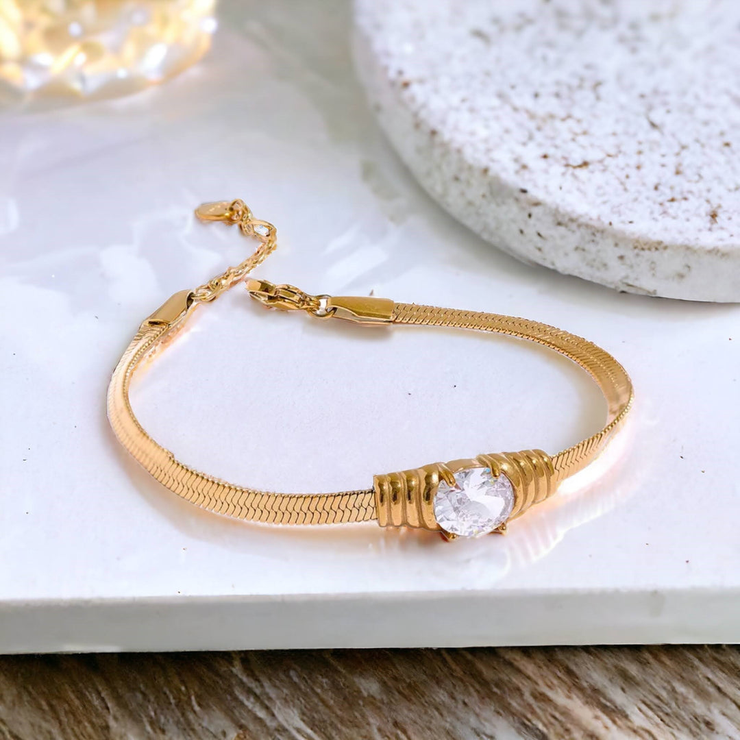 Aurora Radiance Herringbone Bracelet - Sophisticated gold herringbone bracelet featuring a single brilliant-cut cubic zirconia stone.