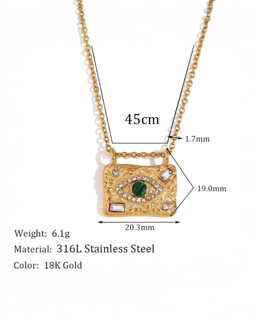 Celestial-inspired gold necklace featuring an intricate eye design with a green stone centerpiece and diamond accents on a textured rectangular pendant from Lia Haddi Modern Jewelry.