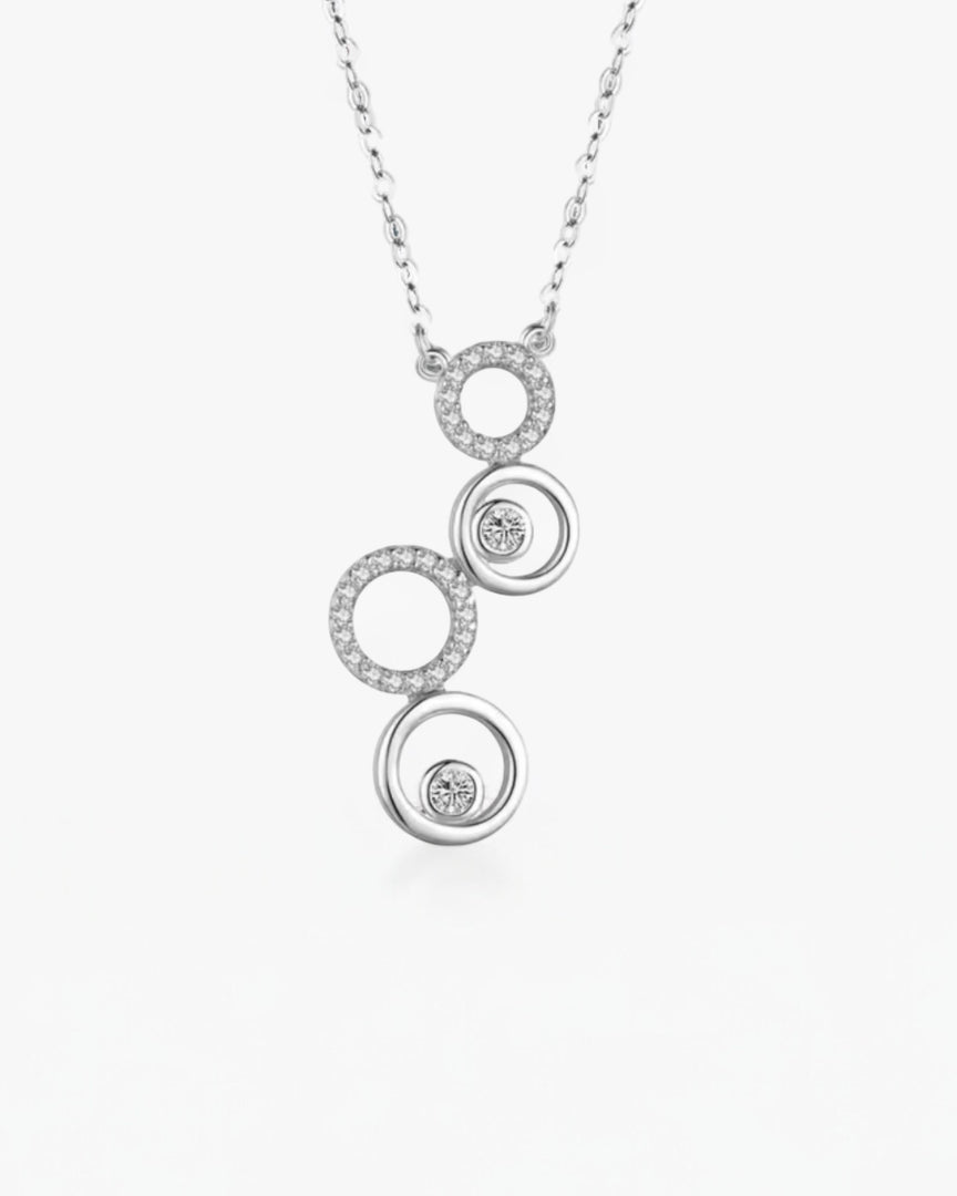 Elegant Circle Harmony Necklace featuring interconnected silver circles adorned with cubic zirconia, symbolizing unity and balance. From Lia Haddi.