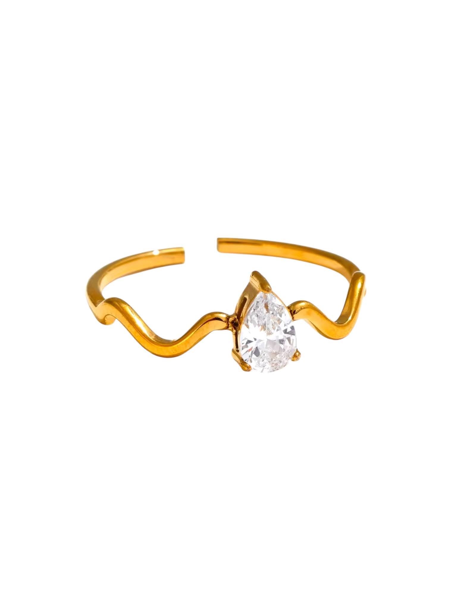 Gold wave ring with a teardrop-shaped crystal centerpiece, a stylish and modern design by Lia Haddi  Modern Jewelry.