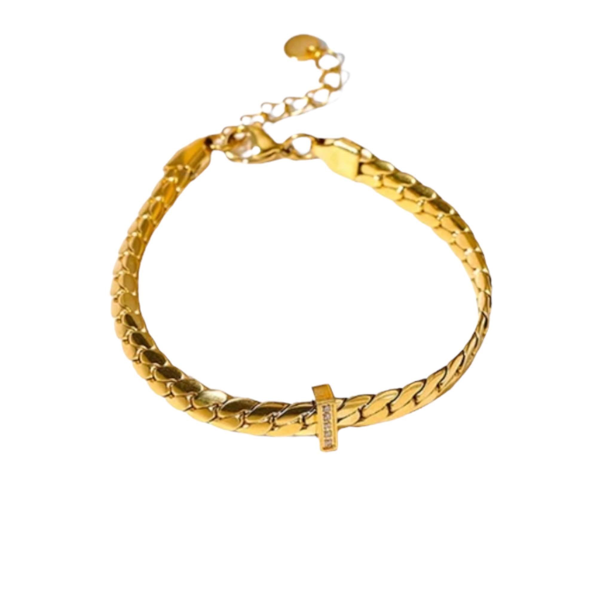 Golden Herringbone Bracelet - Elegant gold bracelet with a herringbone pattern and a central cross detail, perfect for a sophisticated look.