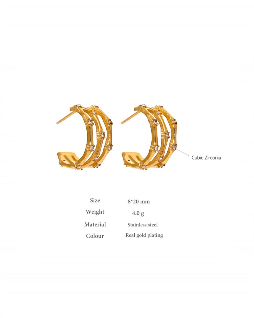 Stunning gold orbit earrings featuring multiple concentric bands accented with sparkling stones, exuding modern elegance and sophistication. From Lia Haddi.