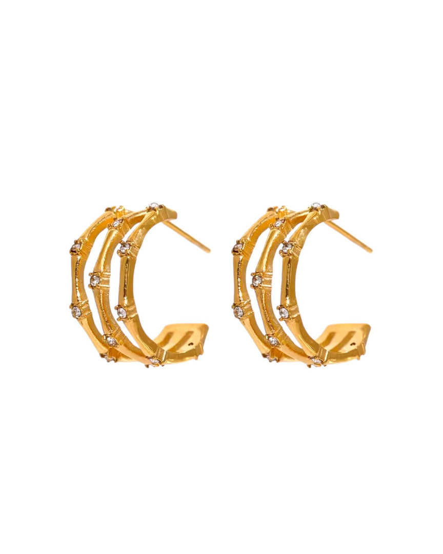 Stunning gold orbit earrings featuring multiple concentric bands accented with sparkling stones, exuding modern elegance and sophistication. From Lia Haddi.