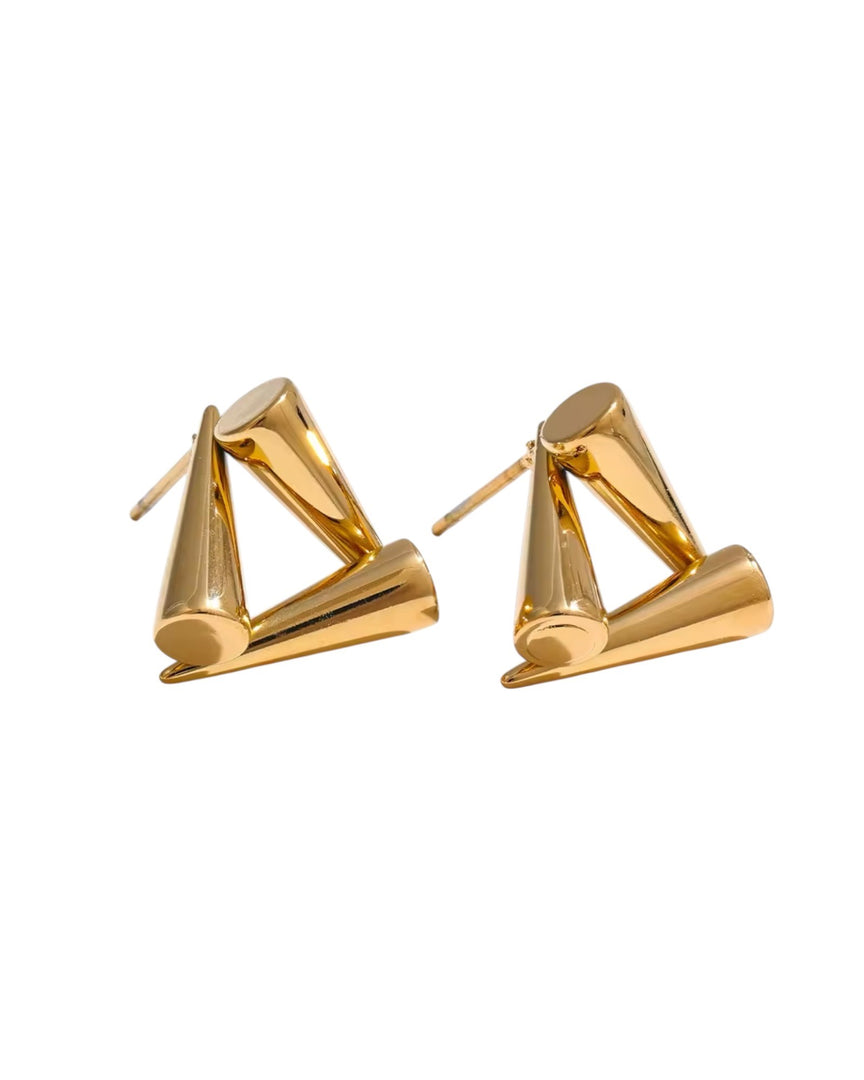 Modern golden pyramid stud earrings with a bold geometric design. From Lia Haddi