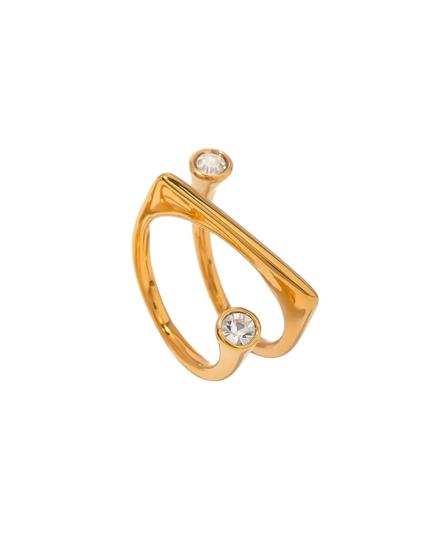 Gold arc-shaped ring featuring two sparkling bezel-set crystals, a modern and stylish design by Lia Haddi Modern Jewelry.