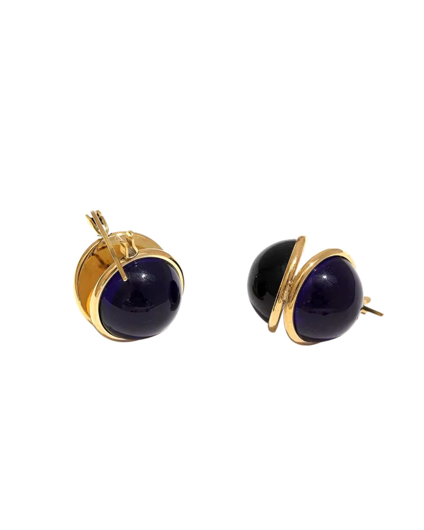 Elegant midnight blue sphere huggie earrings encased in a sleek gold wrap design. From Lia Haddi.