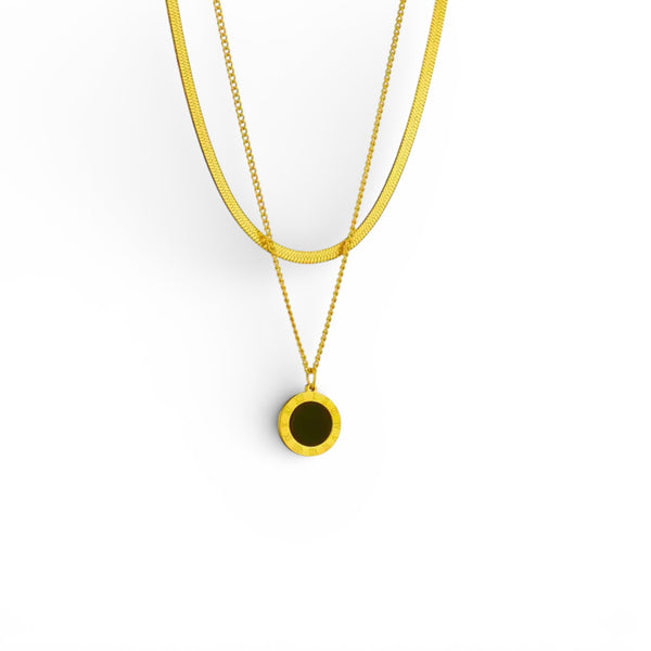 Layered gold necklace with black resin Roman numeral disc pendant in 18K gold plated stainless steel