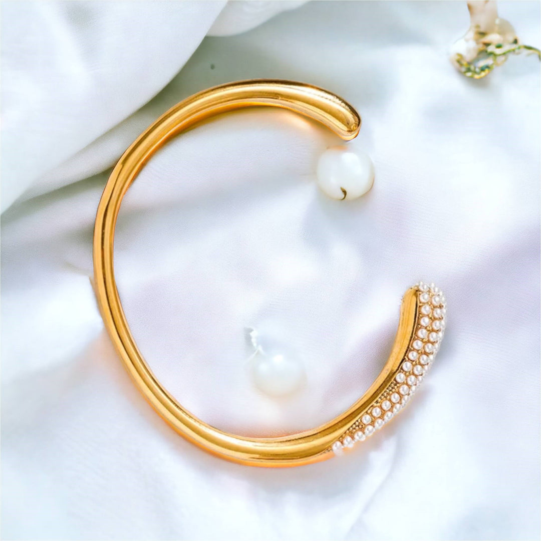 Serene Pearl Cuff Bracelet - Elegant gold cuff bracelet adorned with a row of lustrous pearls, perfect for adding a touch of sophistication to any outfit.